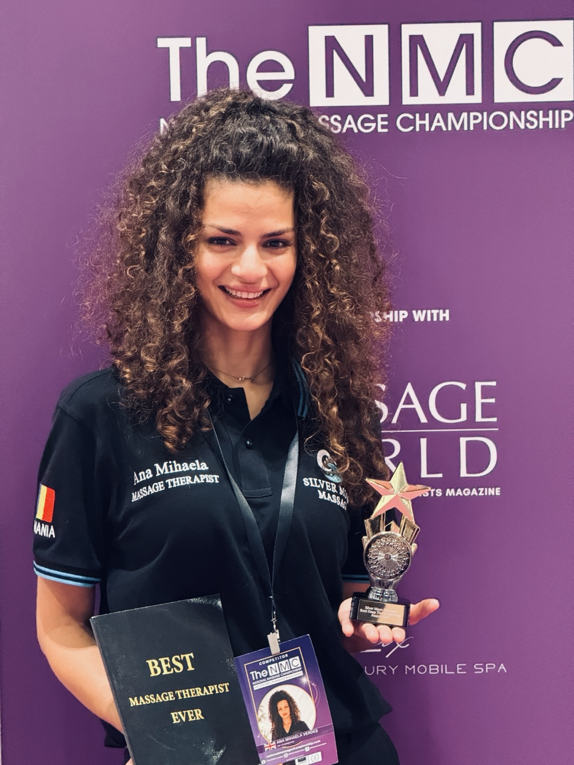Ana Mihaela Cobzariu holding an award at The National Massage Championship.